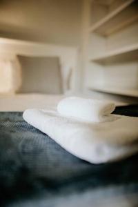 a white object sitting on top of a bed at Die Stal at Antioch in Franschhoek