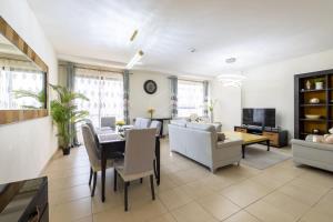 a living room with a couch and a table at Bright apartment on the JBR Beach in Dubai