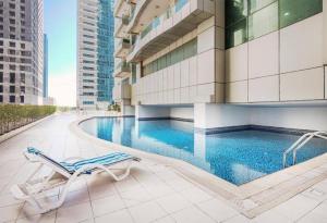 a pool in the middle of a building with a chair at luxury one bed room Apartment in dubai marina pinnacle tower in Dubai