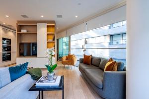a living room with a couch and a table at ARCORE Premium Apartments London Bridge in London