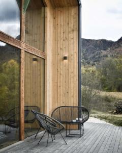 a patio with two chairs and a table on a building at GEIST holiday home in Râşnov