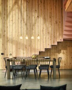 a dining room with a table and chairs and a staircase at GEIST holiday home in Râşnov