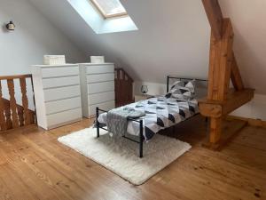 a bedroom with a bed and a skylight at Logement 6 personnes avec SPA in Essômes-sur-Marne