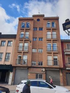 a building with a car parked in front of it at KLOLA in Avila