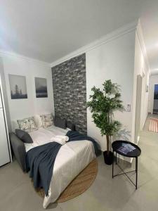 um quarto com uma cama e uma parede de tijolos em Golden Breeze Holidays em Sagres
