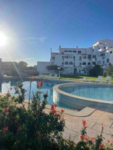 a large swimming pool in front of a building at Golden Breeze Holidays in Sagres