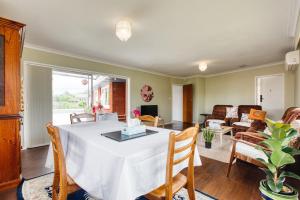 a dining room with a table and a living room at Sweet Home between CBD and University in Hamilton