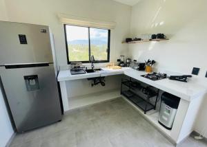 a kitchen with a white counter and a refrigerator at La Ventana Apartments Torote #5 in La Ventana