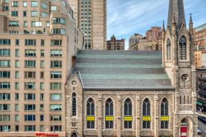 an old church in a city with tall buildings at UES 1br w gym doorman walk to central park NYC-1332 in New York