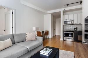 a living room with a couch and a table at FiDi 1br w doorman gym nr wall street NYC-1342 in New York