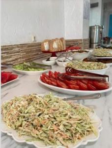 a buffet with plates of food on a table at Hotel Georgia in Gonio