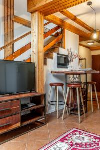 a living room with a large television and a bar at Apartmán Mezonet na Námestí Košice in Košice