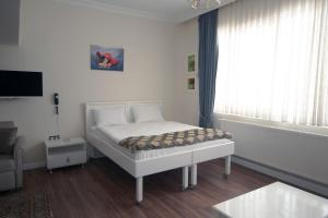 a small bedroom with a bed with a window at IQ Hotel Beyoğlu in Istanbul