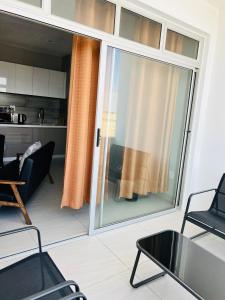 a living room with a large sliding glass door at Coastal Bliss at Ongwe in Swakopmund