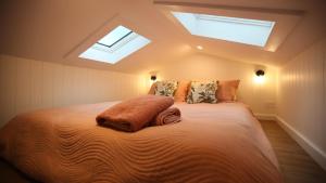 a bedroom with a large bed with a skylight at Wild Life Cabin 2 - Grampians in Halls Gap