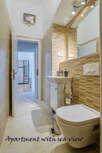 a bathroom with a toilet and a sink at Summertime Apartments in Zadar