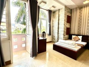 a bedroom with a bed and a large window at Phuc Hung Hotel in Rach Gia