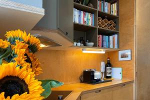 a kitchen with a counter with a sunflower on a table at Quirky and Modern Clerkenwell Apartment in London