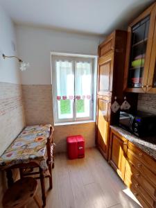 a small kitchen with a table and a window at Appartamento Pelmo in Borca di Cadore