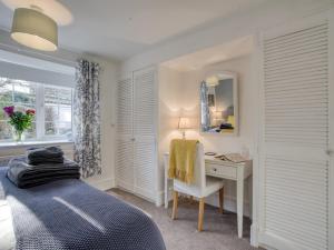 a bedroom with a bed and a desk and a mirror at 1 bed in Richmond 77600 in Easby