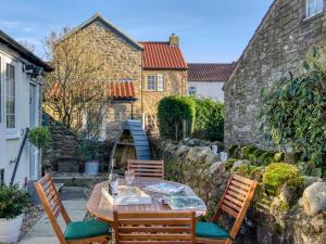 a patio with a table and chairs and a building at 1 bed in Richmond 77600 in Easby