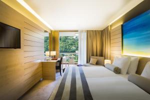 a hotel room with a bed and a desk at Hotel Excelsior - Liburnia in Lovran