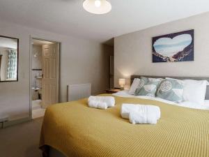 a bedroom with a large bed with two pillows on it at 4 Bed in New Quay 78589 in New Quay