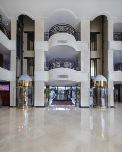 a large building with a lobby with two elevators at Grand Mogador City Center Casablanca in Casablanca