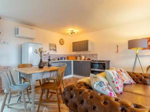 uma cozinha e sala de estar com um sofá e uma mesa em 2 Bed in South Molton 78302 em Kings Nympton