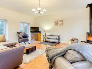 a living room with a couch and a tv at 4 Bed in Parkham 76452 in Parkham