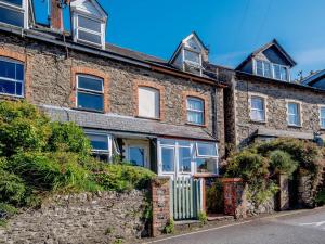 an old brick house with a white door at 3 Bed in Lynton 78823 in Lynmouth