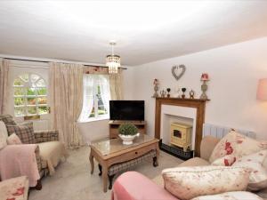 a living room with a fireplace and a tv at 1 Bed in Spilsby 79226 in Old Bolingbroke