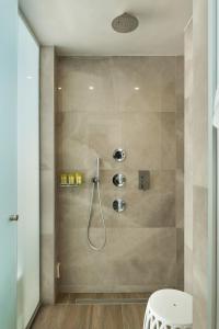 a bathroom with a shower with a toilet and a sink at Elia Portou Luxury Residence in Chania Town