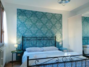 a bedroom with a bed with a blue wall at Two Steps from Rialto in Venice