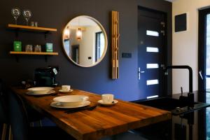 a wooden table with a mirror in a room at Forestlux Vendégház in Zebegény