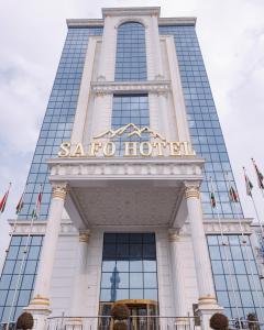 een hoog gebouw met een bord erop bij Safo Dushanbe in Doesjanbe