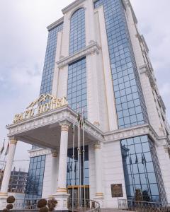 a building with a sign on the front of it at Safo Dushanbe in Dushanbe