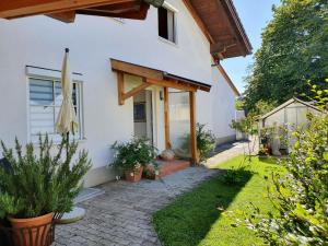a white house with a pathway leading to the front door at Ferienwohnung Filser in Prien am Chiemsee