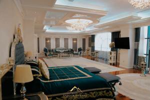 a large room with a bed and a living room at Safo Dushanbe in Dushanbe