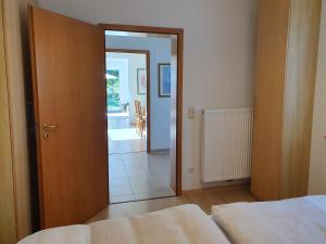 a bedroom with a door open to a living room at Ferienwohnung Filser in Prien am Chiemsee