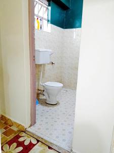 a bathroom with a toilet in a room at Cozy Haven Slumber in Nanyuki