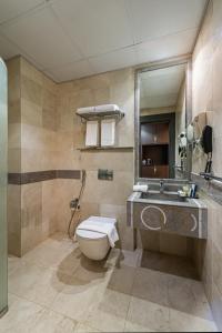 a bathroom with a toilet and a sink at Best Western Ajyad Makkah in Mecca