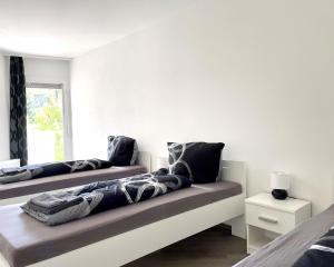 a living room with two beds and a window at Studios im Haus Deutsch Krone I home2share in Bad Rothenfelde