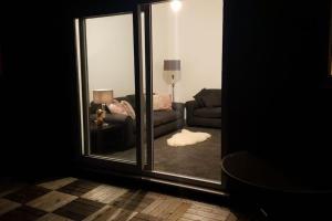 a living room with a window and a couch at Welcome to Tring Cymric Home in Tring