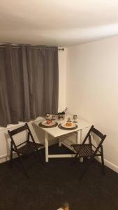 a white table and two chairs in a room at Welcome to Tring Cymric Home in Tring