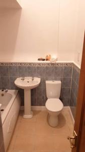 a bathroom with a toilet and a sink at Welcome to Tring Cymric Home in Tring