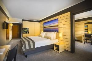 a hotel room with a bed and a desk at Hotel Excelsior - Liburnia in Lovran