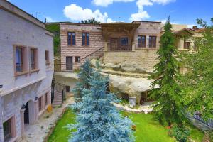 a christmas tree in the yard of a building at Cappadocia Fairy Chimneys Minia Cave Hotel in Ortahisar