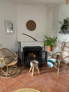 a living room with two chairs and a fireplace at El Caliu in Barcelona