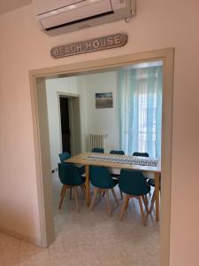 a dining room with a table and chairs at Beach House Fronte Mare Viserba in Rimini